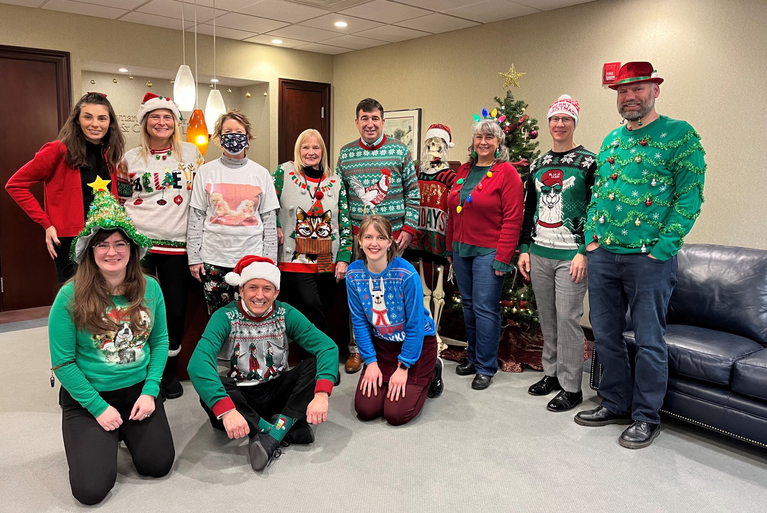 A group of members of the firm posing in their holiday-themed outfits
